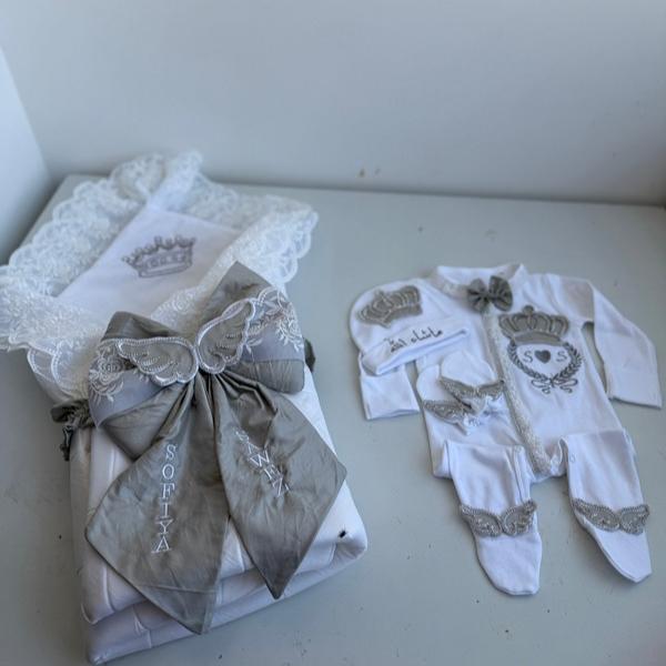 white and black winged and crowned romper set with elegant wrapper